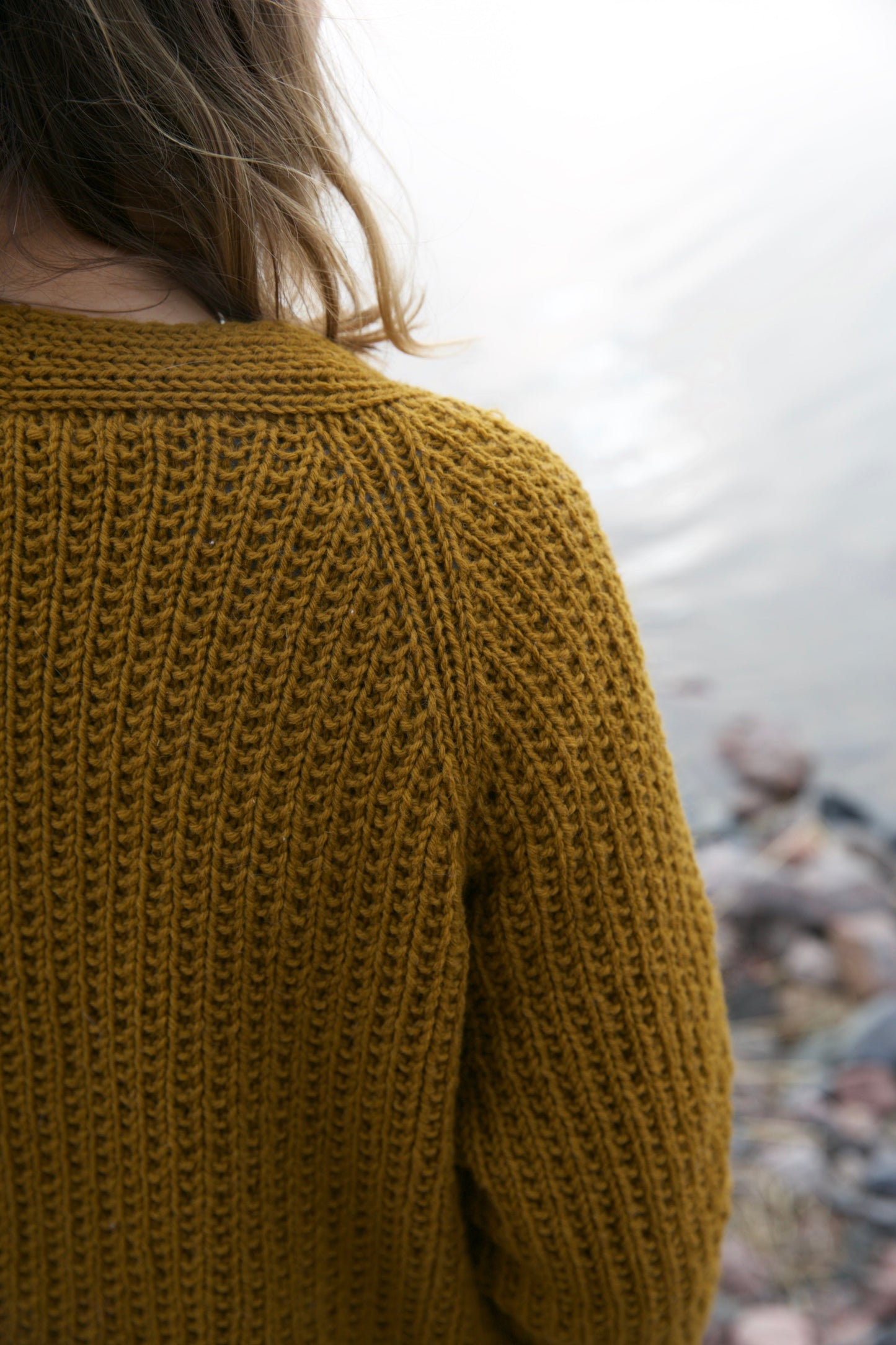 Cardigan knitting pattern, close-up of texture and neckline, brown yarn
